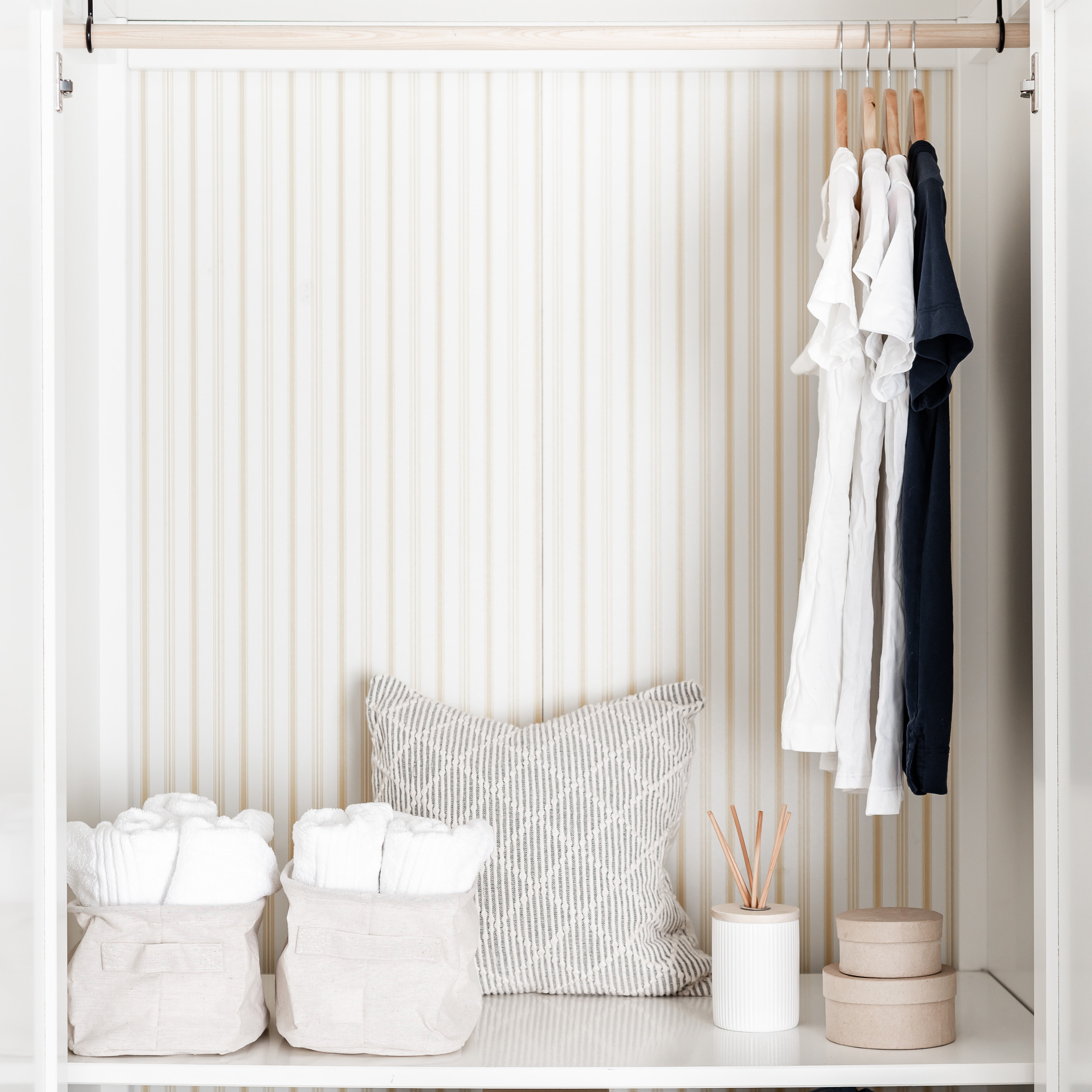 white-and-black-shirts-on-a-wooden-hanger-in-a-wardrobe