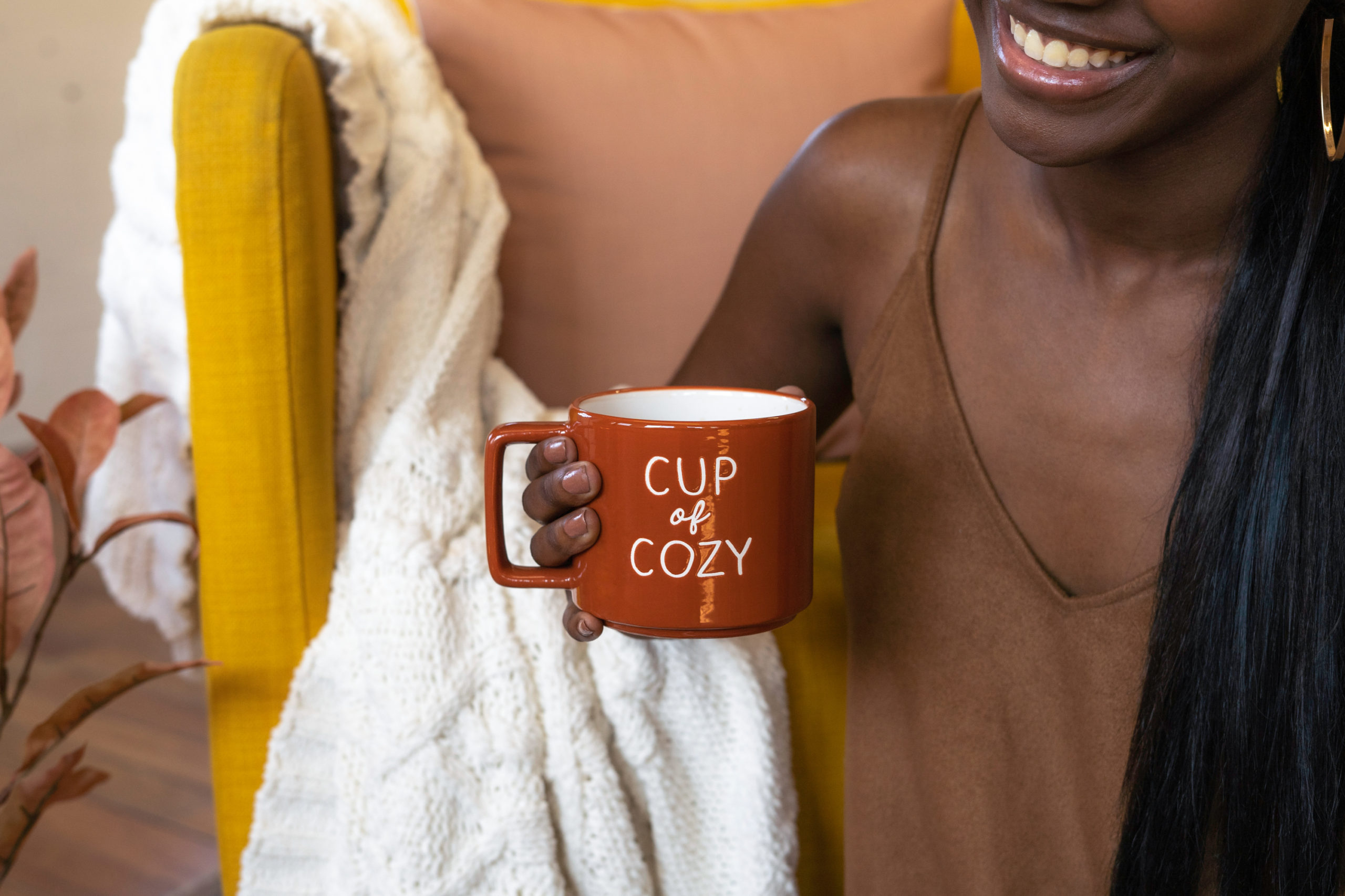black-lady-holding-a-red-cup-of-coffee-with-cup-of-cozy-written-on-it