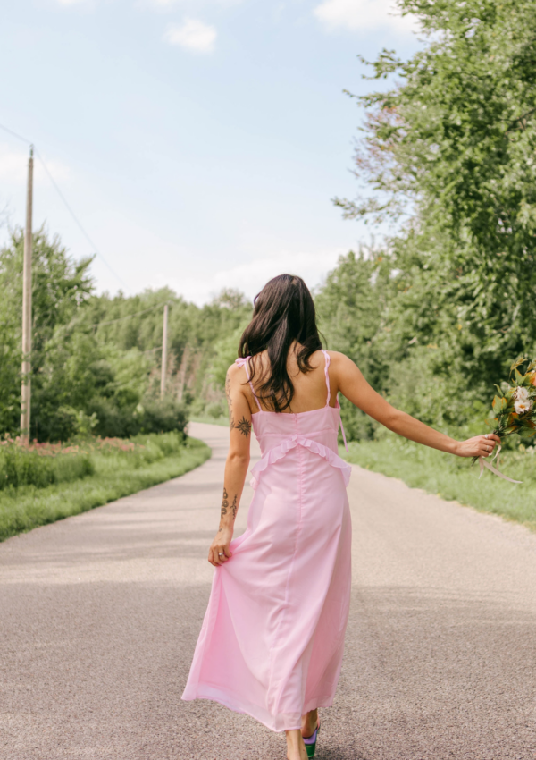 white-brunette-lady-wearing-a-pink-sleeveless-long-dress-and-taking-a-walk-in-nature