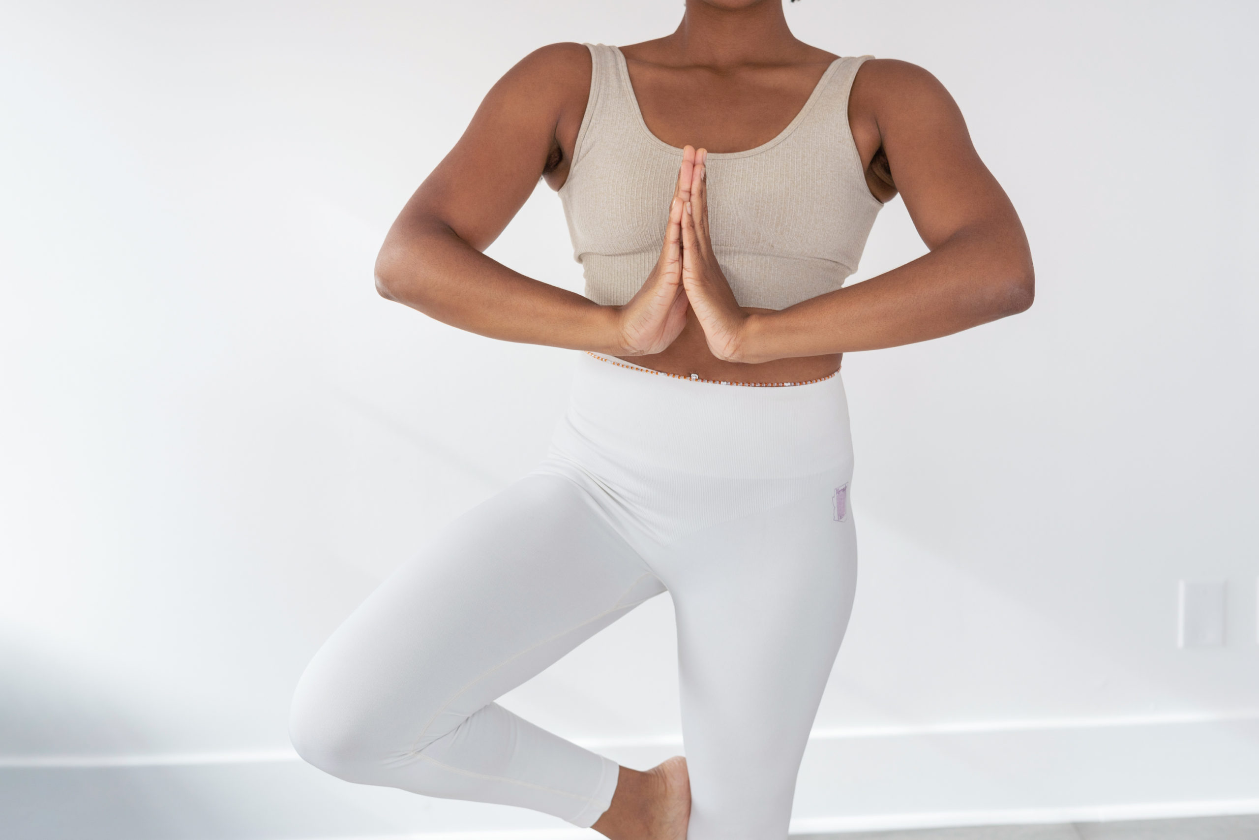 black-lady-practicing-yoga-with-one-foot-on-the-floor-and-the-other-on-the-knee