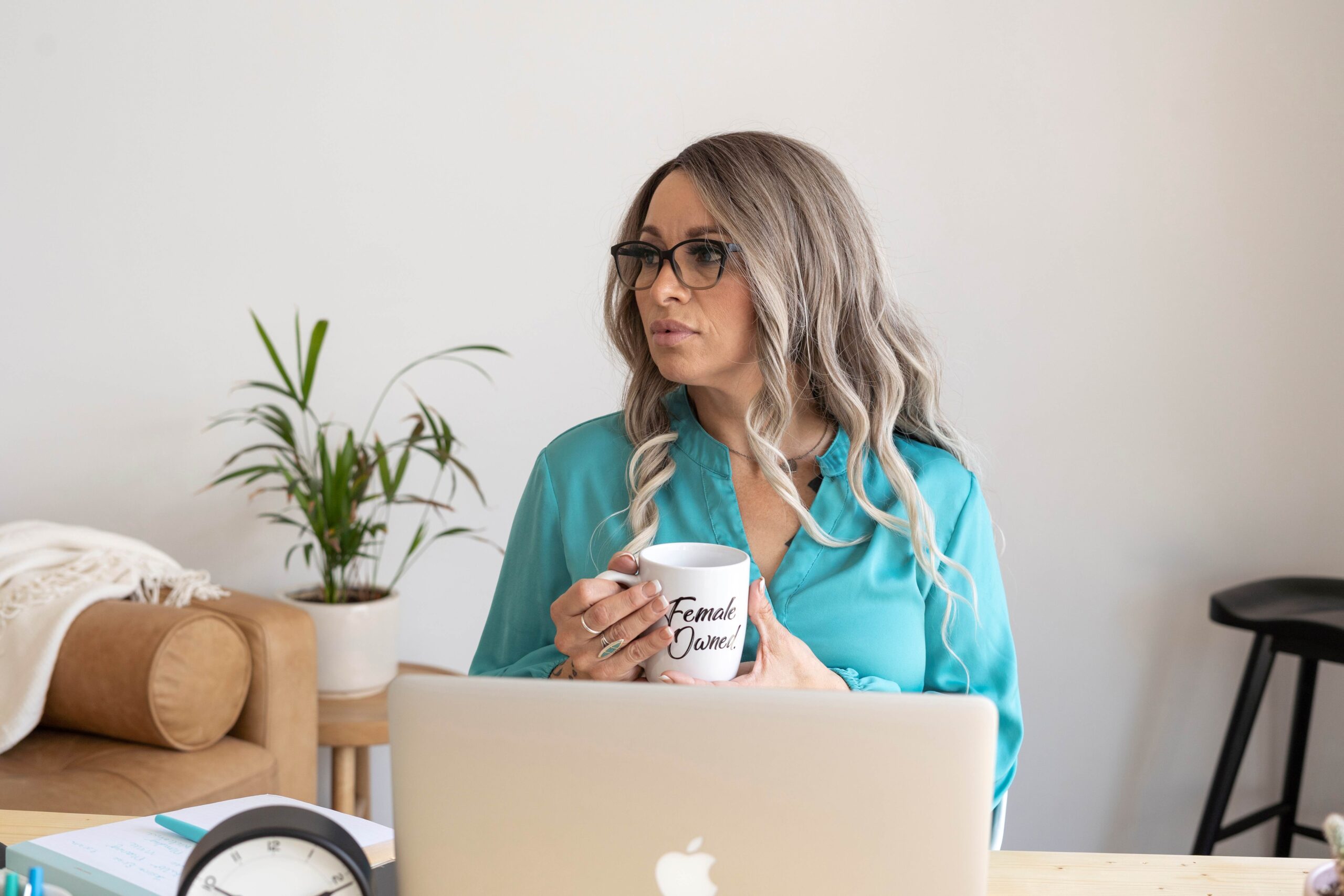 whit-lady-wearing-a-blue-blouse-and-sitting-in-front-of-her-laptop