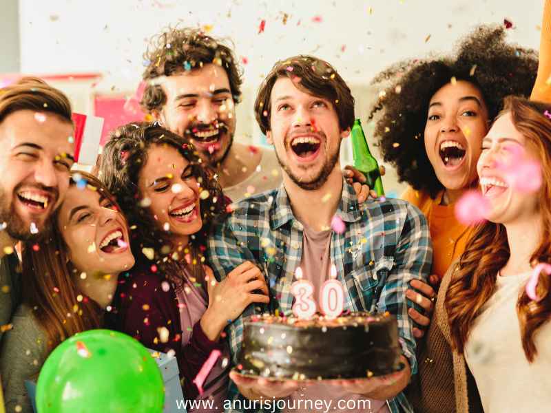 Group-of-friends-celebrating-with-a-cake-as-30-Budget-Friendly-Birthday-Party-Ideas-For-Adults