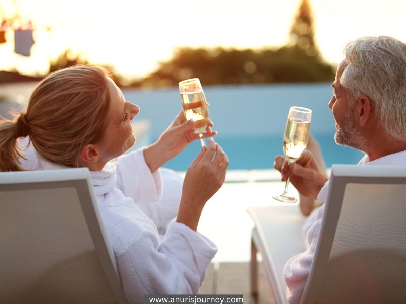 couples-sipping-wine-on-a-beanch-as-an-anniversary-getaway-ideas