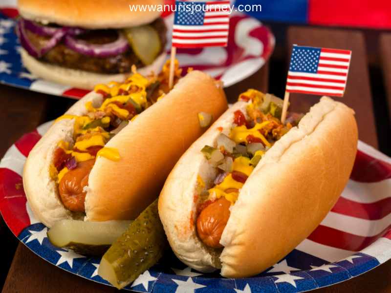 Two-hotdog-snacks-stucked-with-American-mini-flags-as-39-Easy-4th-of-July-Snacks-That-Are-Perfect-for-Any-Party