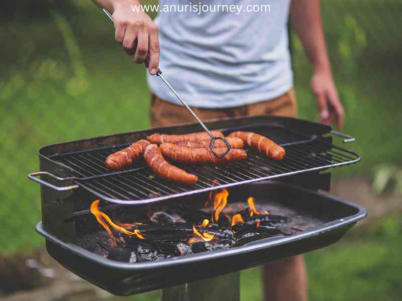 A-man-grilling-sausages-as-35-Epic-Fathers-Day-Grilling-Recipes-for-the-Best-Celebration-Ever.