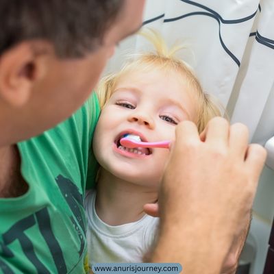 dad-holding-a-child-while-brushing