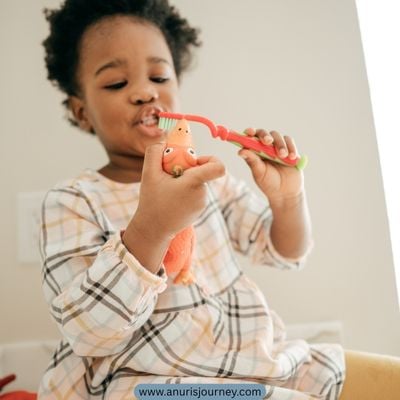 happy-toddler-brushing-a-toys-teeth-as-one-of-The-Secret-to-Getting-a-Toddler-to-Brush-Their-Teeth-Without-Tears