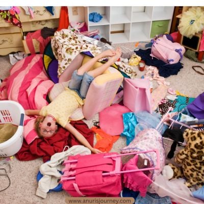 Toddler-playing-on-a-pile-of-cloth-as-one-of-how-to-Organize-Kids&rsquo;-Clothes-And-Stop-the-Endless-Laundry-Pile