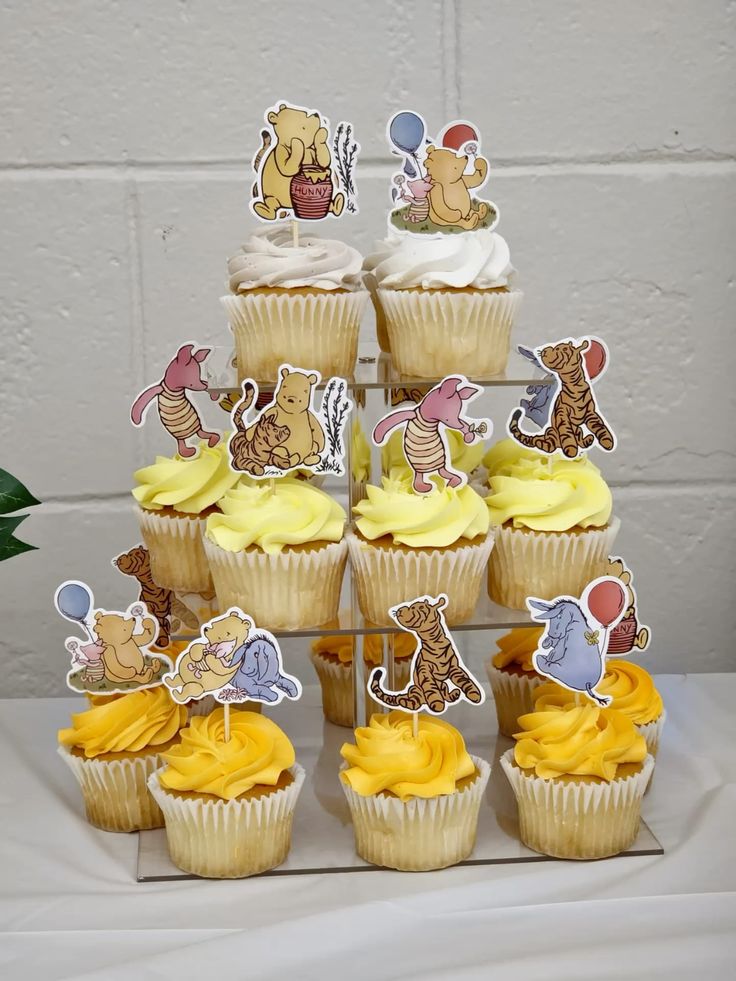 Winnie the Pooh baby shower dessert table with cupcakes
